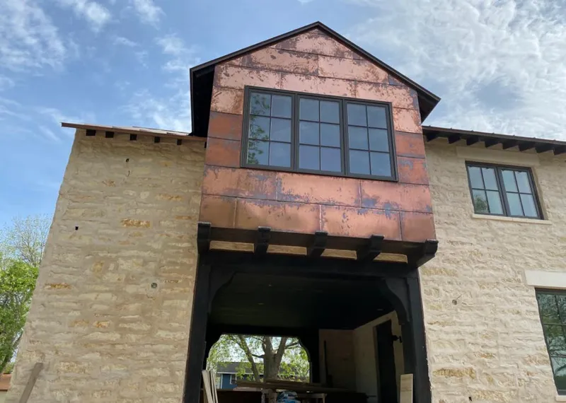 Copper metal panel facade on a stone building for Skylight Installation in Vinton
